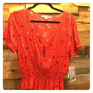 Poppy-colored floral blouse